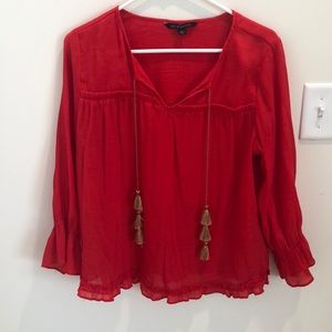 Red blouse with gold tassels